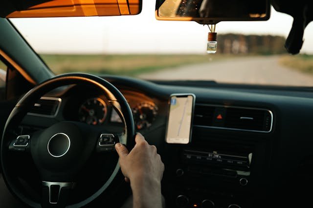 Driver holding steering wheel on smooth road after suspension service in Oklahoma City